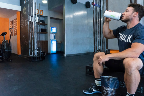 person in black and white nike sneakers sitting on black leather couch