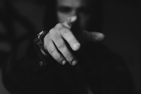 grayscale photo of person holding hands