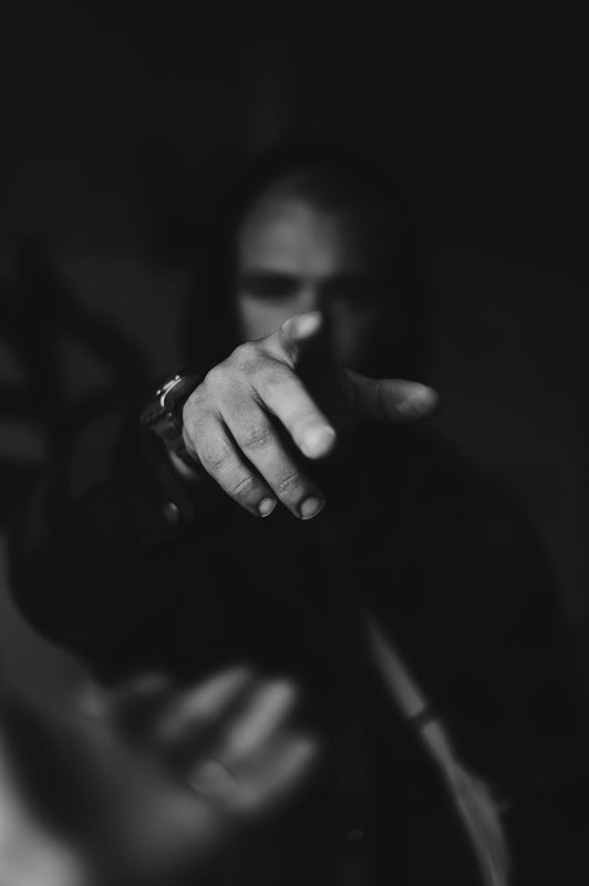 grayscale photo of person holding hands