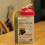 a bag of vegan protein sitting on top of a wooden table