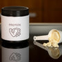 a container of protein powder next to a spoon