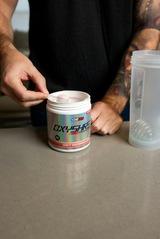 a man with a tattoo on his arm and a cup of coffee