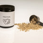 a jar of protein powder next to a scoop of protein powder