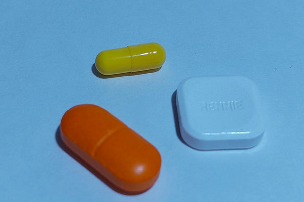 A group of three pills sitting next to each other