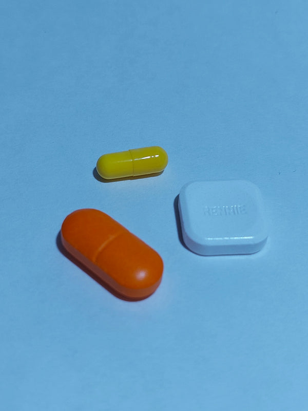 A group of three pills sitting next to each other