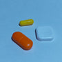 A group of three pills sitting next to each other