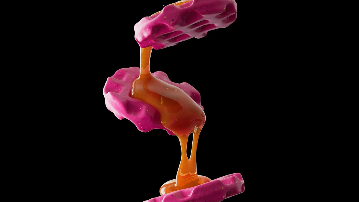 Pink waffles drizzled with a golden sauce.